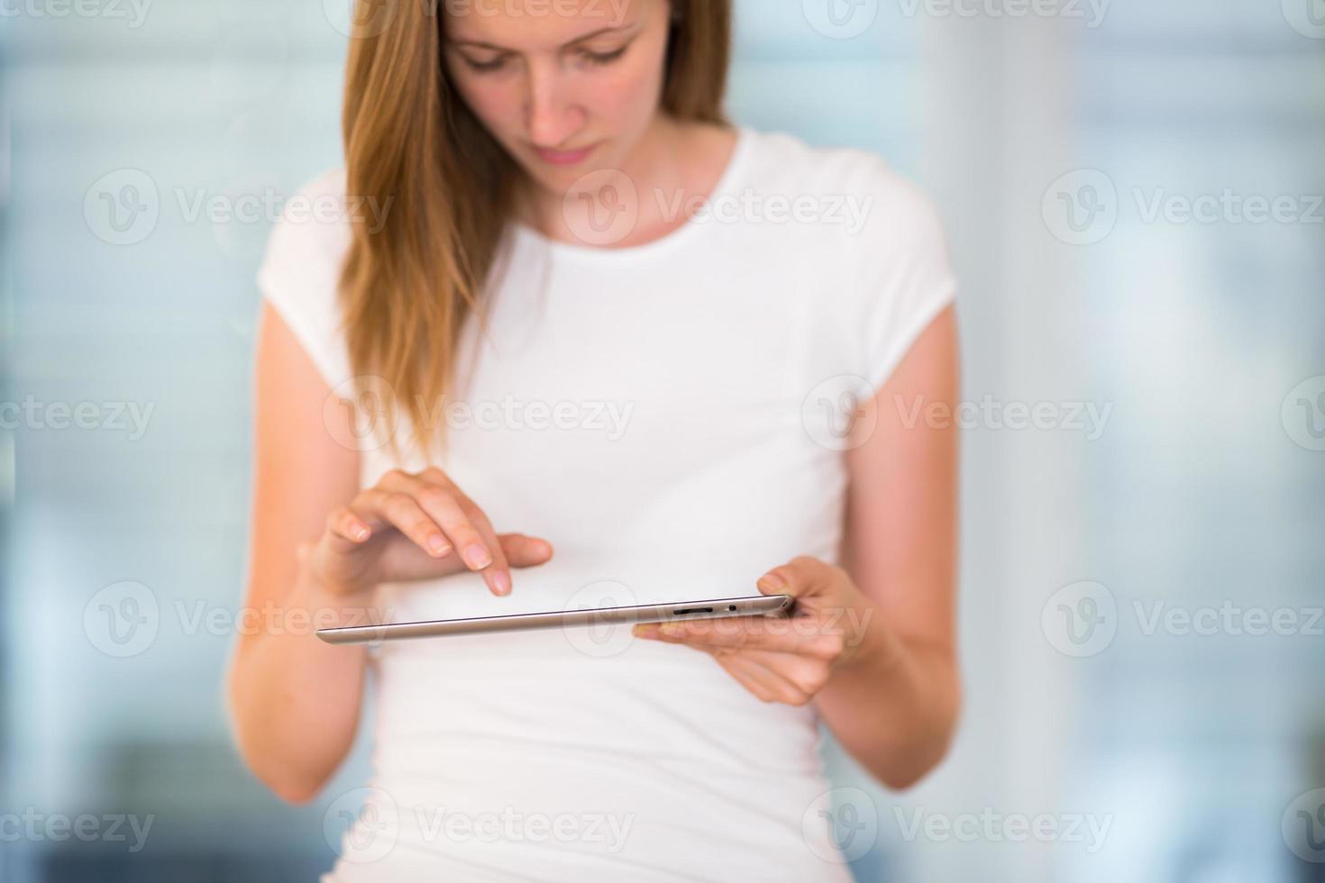 bella, giovane donna d'affari utilizzando il suo tablet foto
