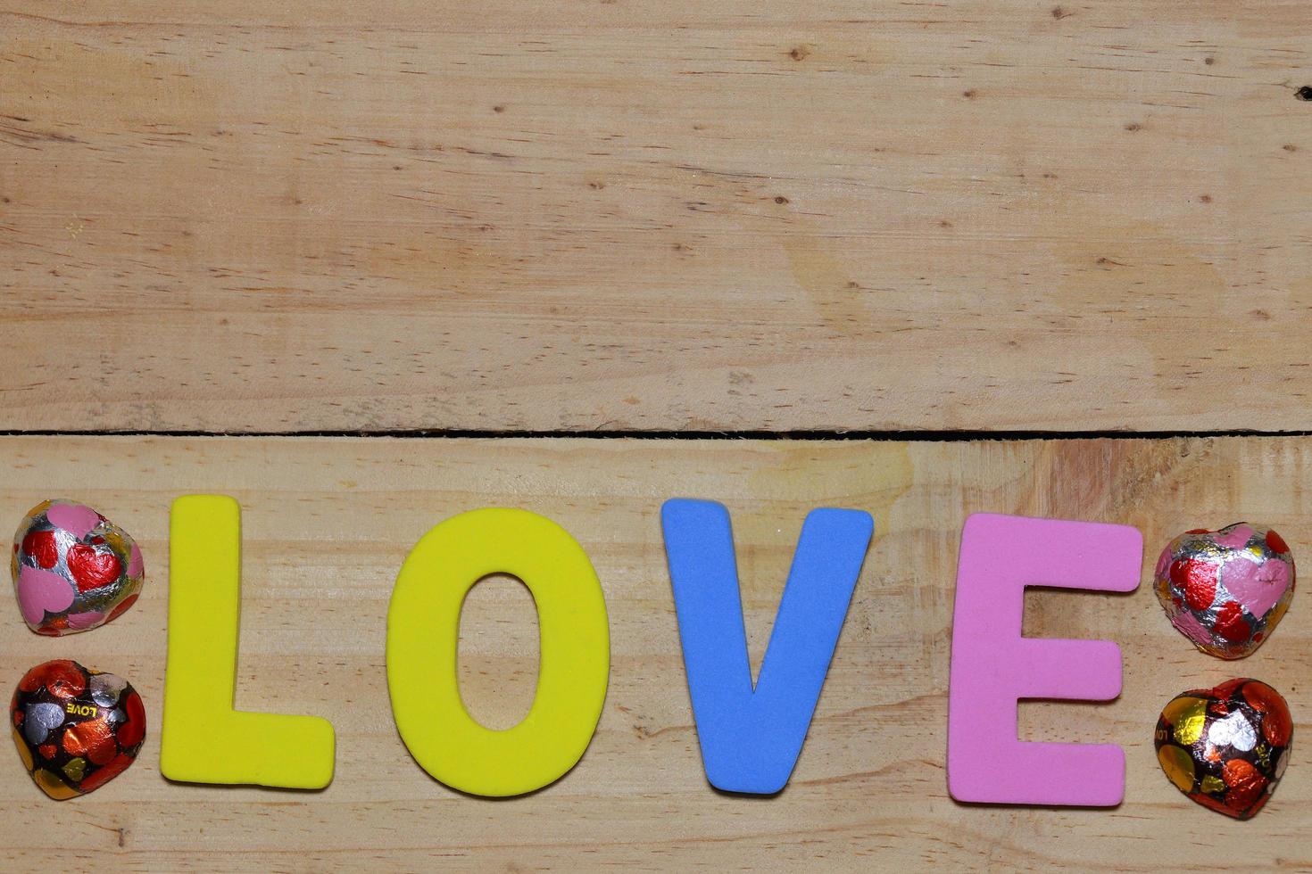 lettere d'amore e cuore di cioccolato sul pavimento di legno. sfondo San Valentino con i cuori. concetto di San Valentino. spazio per il testo. foto