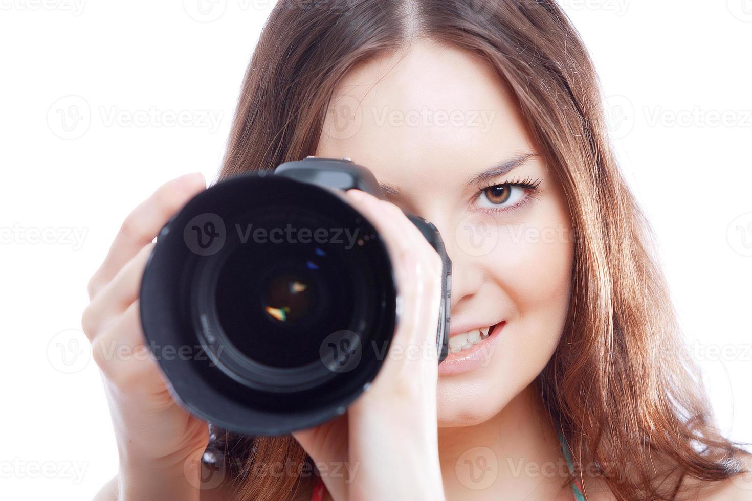 donna sorridente con fotocamera professionale foto