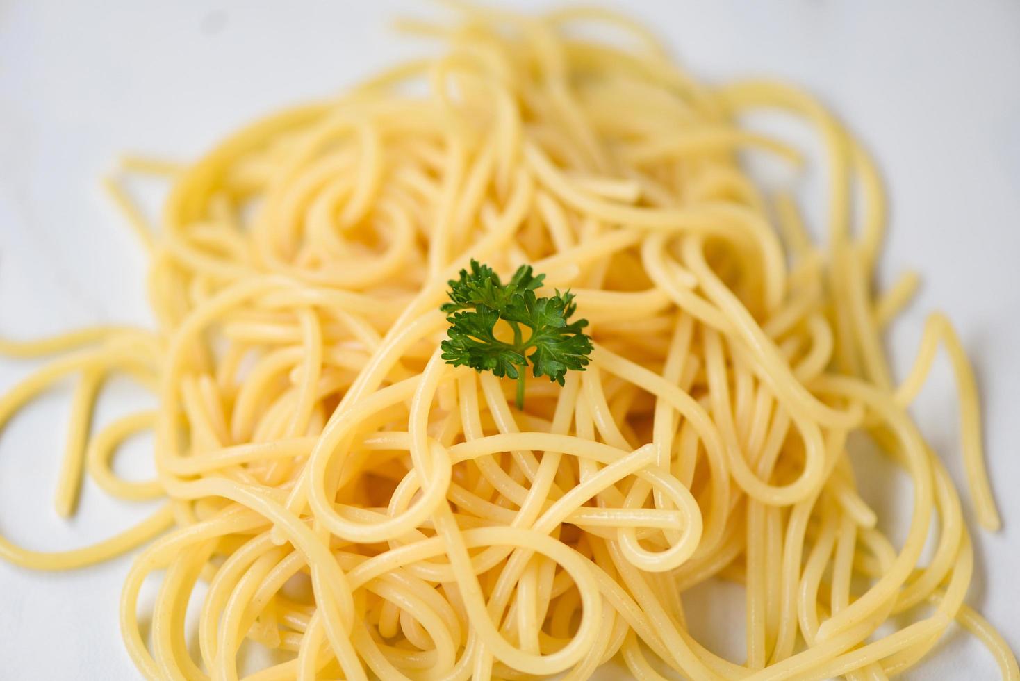 spaghetti italiani serviti su piatto bianco e prezzemolo verde spaghetti cibo e concetto di menu foto