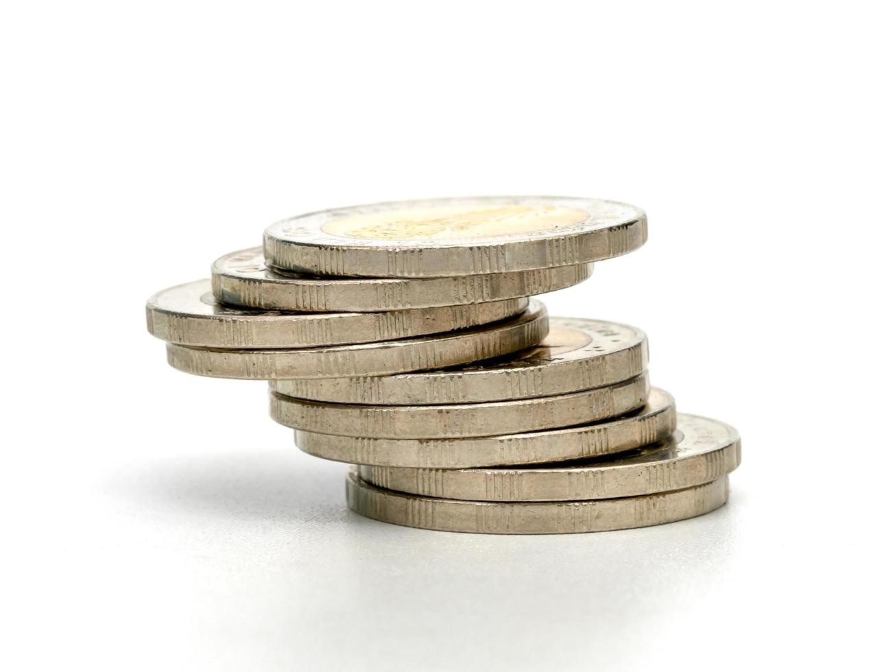 pile di monete d'argento del primo piano isolate su priorità bassa bianca foto