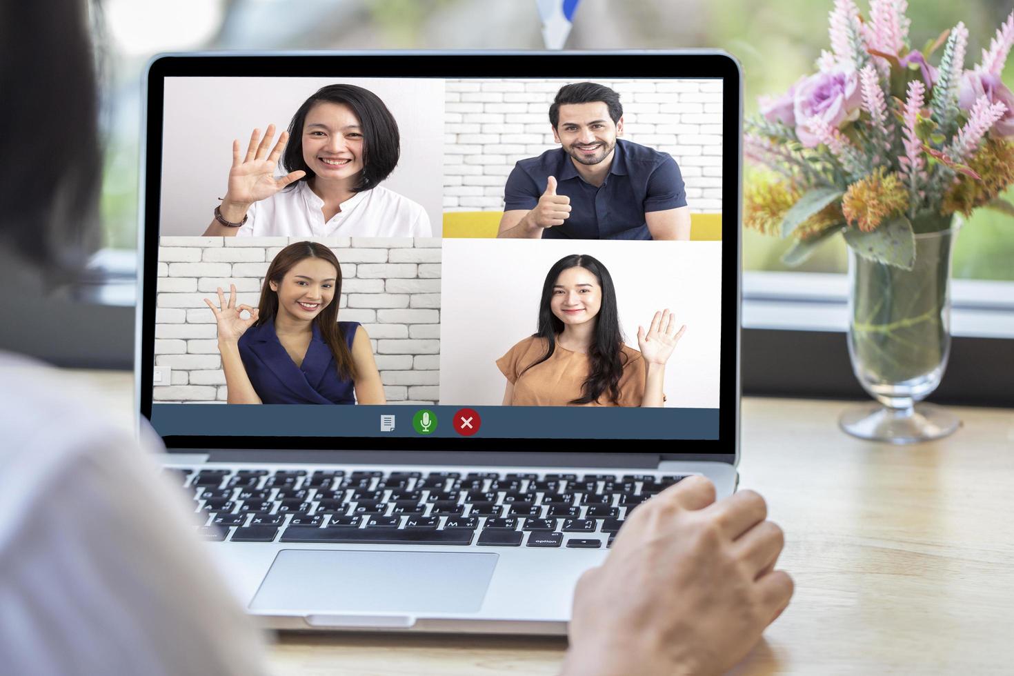 vista posteriore della donna che parla alla chat video con i colleghi utilizzando la webcam del laptop in videoconferenza, riunione online di lavoro intelligente del team aziendale in videochiamata da casa foto