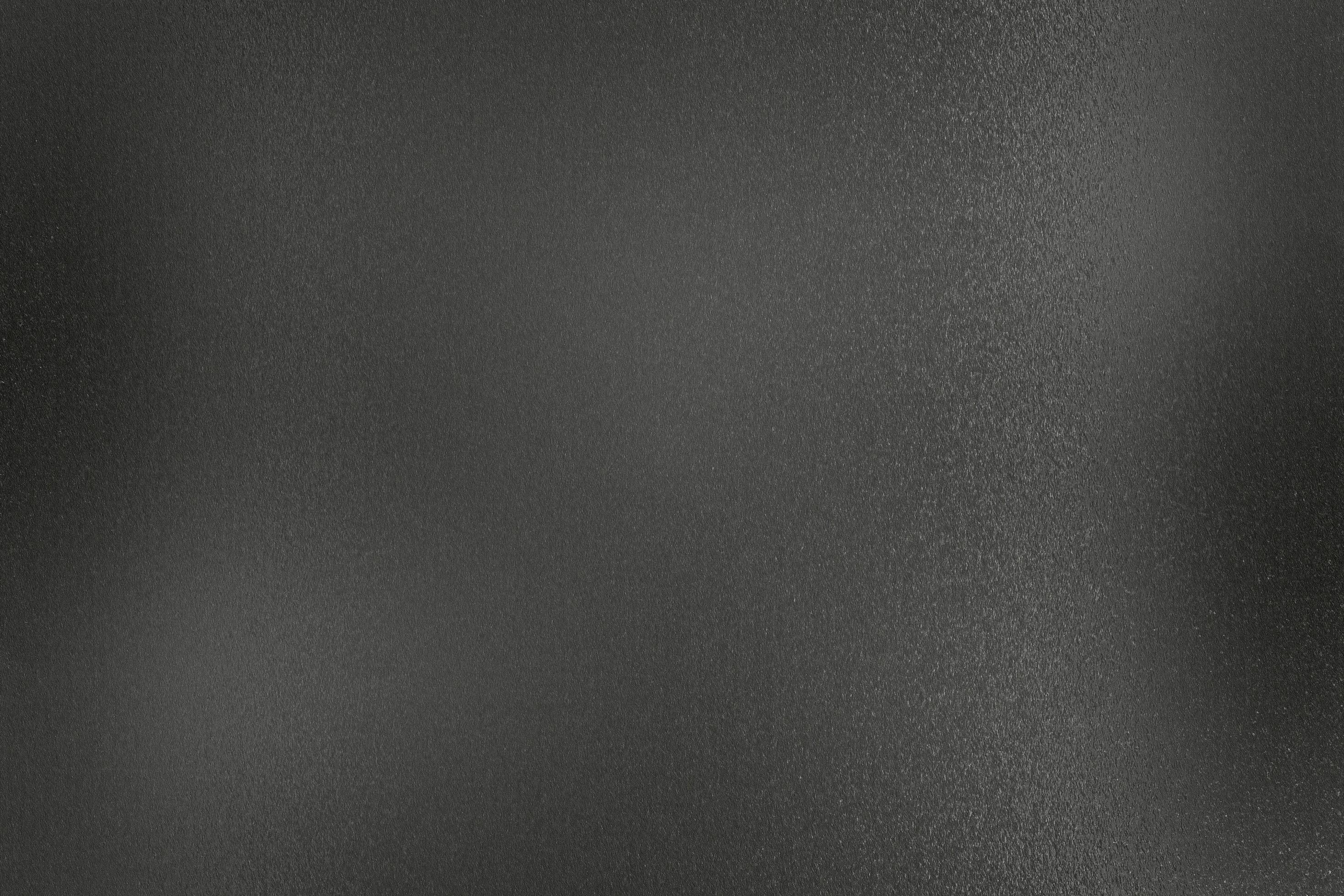 parete di metallo grezzo nero vecchio sporco, fondo astratto di struttura foto