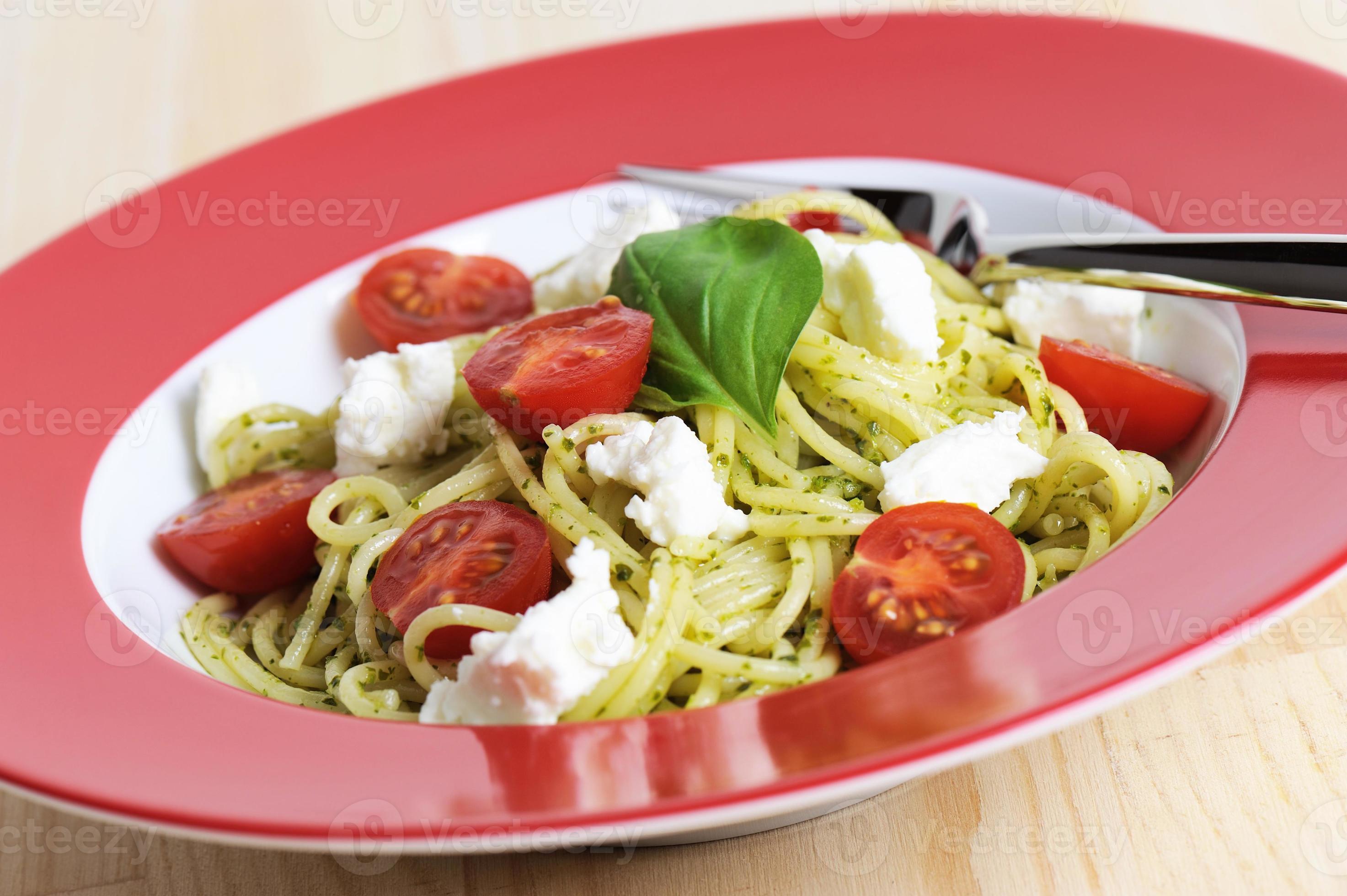 spaghetti di pasta con pesto e pomodori formaggio rosso piatto di capra  769329 Stock Photo su Vecteezy