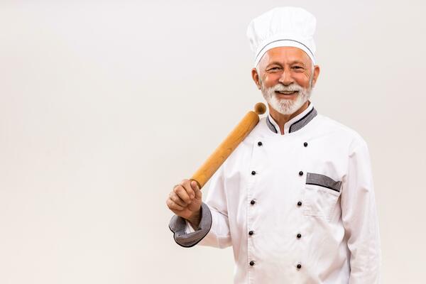 un' vicino - su tiro di un' giovane donna indossare un' dello chef cappello  e grembiule mentre preparazione un' delizioso pasto nel un' bene -  attrezzata cucina. generativo ai 26812154 Stock Photo su Vecteezy