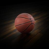 palla da basket sul parquet con sfondo nero foto