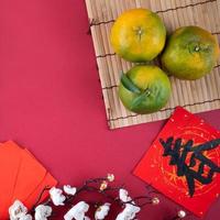 vista dall'alto di mandarino mandarino fresco su sfondo rosso per il capodanno lunare cinese. foto