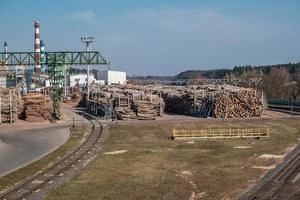 tubi della segheria dell'impianto di impresa di lavorazione del legno vicino al fiume. concetto di inquinamento atmosferico. paesaggio industriale inquinamento ambientale rifiuti di centrale termica foto