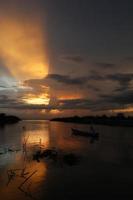 pescatore sulla sua barca al tramonto. barca di pescatori al tramonto foto