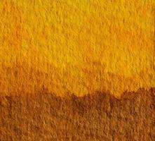 sfondo di arte della pittura a mano dell'acquerello giallo e marrone. concetto di tonalità della terra per i colori naturali del suolo o del suolo. foto