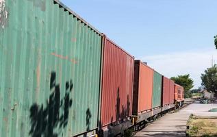 la locomotiva diesel-elettrica è in marcia con il vagone container. foto