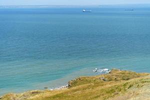 paesaggio marino che domina le colline con erba secca foto