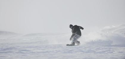 lo snowboarder freestyle salta e cavalca foto