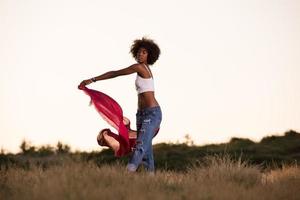 nero ragazza balli all'aperto nel un' prato foto