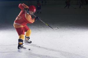 adolescente ghiaccio hockey giocatore nel azione foto