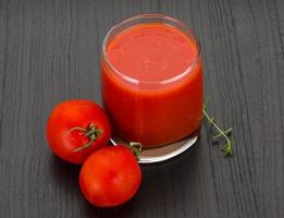 pomodoro succo su di legno sfondo foto