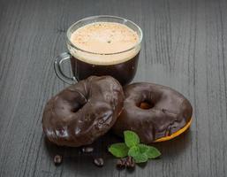 caffè con ciambelle su di legno sfondo foto