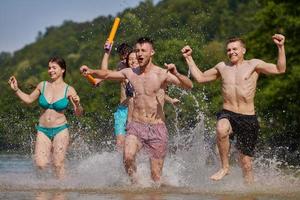 gruppo di contento amici avendo divertimento su fiume foto