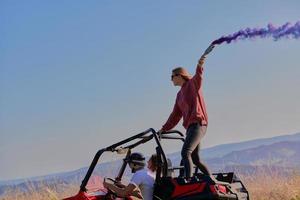 eccitato persone avendo divertimento godendo bellissimo soleggiato giorno Tenere colorato torce mentre guida un' via strada passeggino auto foto