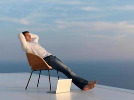 rilassato giovane uomo a casa su balcone foto