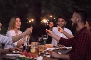 amici avendo picnic francese cena festa all'aperto durante estate vacanza foto