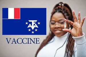 africano donna mostrare vaccino per francese meridionale e antartico terre. vaccinazione di Africa paesi concetto. foto