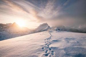 impronte innevate sulla cresta della montagna foto