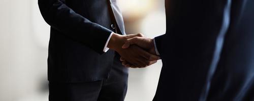 negoziare con successo e concetto di stretta di mano, due uomini d'affari si stringono la mano con il partner per celebrare la partnership e il lavoro di squadra, affare