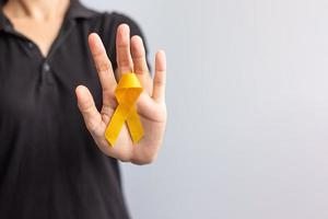 giornata di prevenzione del suicidio, infanzia, sarcoma, mese di sensibilizzazione sul cancro alle ossa e alla vescica, nastro giallo per sostenere la vita e la malattia delle persone. concetto di assistenza sanitaria per bambini e giornata mondiale del cancro foto