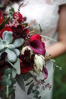 rosso nozze mazzo di sposa. floristica, festivo decorazione di fresco fiori di il cerimonia. simbolo di amore, Rose nel pastello sfumature, succulente nel decorativo elementi, fiori selvatici. spazio per testo foto