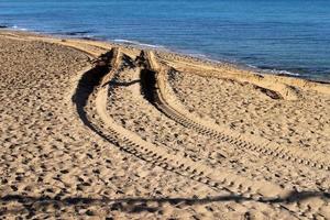 impronte nel il sabbia su il sponde di il mediterraneo mare. foto