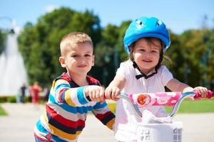 ragazzo e ragazza nel parco apprendimento per cavalcata un' bicicletta foto