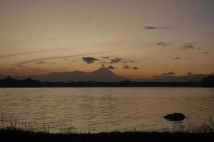 panoramico Visualizza di Alba con un' speciale arancia effetto contro il sfondo di montagne e dighe foto