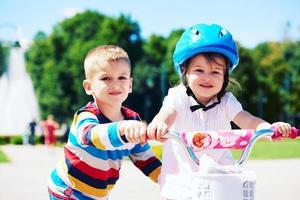 ragazzo e ragazza nel parco apprendimento per cavalcata un' bicicletta foto