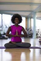 africano americano donna esercizio yoga nel Palestra foto