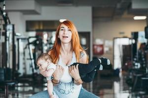 giovane madre con sua giovane figlio nel il Palestra foto