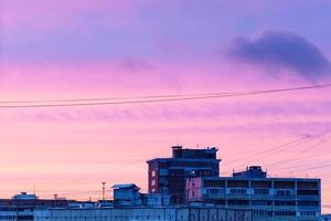 blu e rosa tramonto cielo al di sopra di case nel inverno foto