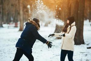 ragazzo e ragazza giocando con neve foto