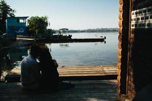 abbracciare uomo e donna nel amore su di legno molo foto