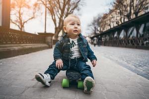 poco divertente ragazzo con skateboard su il strada foto