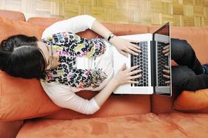 uno giovane donna Lavorando su il computer portatile foto