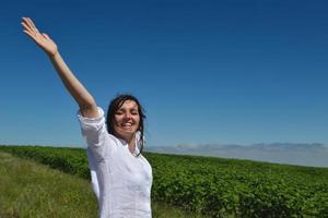 giovane donna felice in campo verde foto