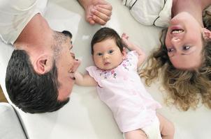 interno ritratto con contento giovane famiglia e carino poco bambino foto