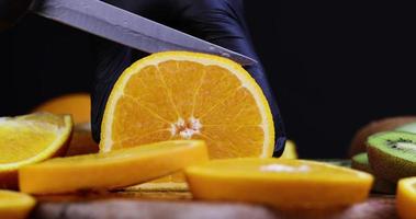 tagliare un arancia in pezzi su un' di legno chopping tavola foto
