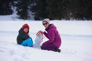 contento famiglia edificio pupazzo di neve foto