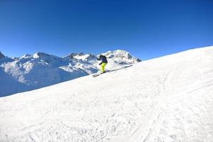 sciare sulla neve fresca nella stagione invernale in una bella giornata di sole foto