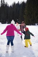 contento famiglia edificio pupazzo di neve foto