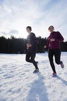 coppia jogging al di fuori su neve foto