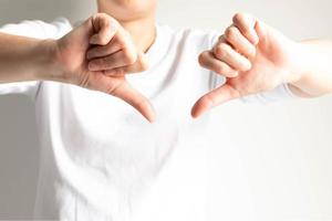 un' persona postura Due mani pollici giù per mostrando sensazione antipatia o sensazione cattivo. foto