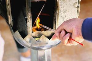 mani di tailandese persone hold incenso bastoni per culto il Budda Immagine nel il tempio. il culto di il Budda è piace dando rispetto per il Budda nel buddismo. foto